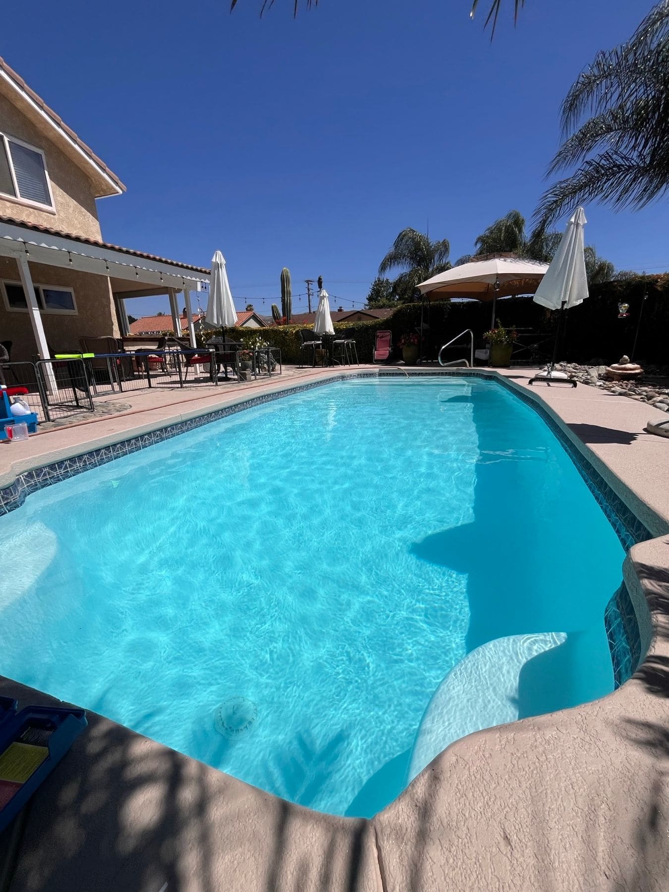 Spanish-style backyard pool, clean and balanced